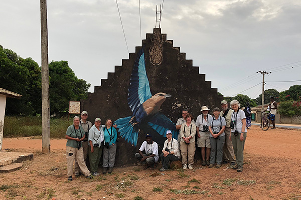 In front of mural in The Gambia