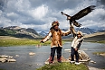 Family showing off their hunting eagle