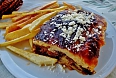 Mousaka, a baked dish made with thick layers of eggplant, beef in tomato sauce, and topped with béchamel sauce