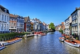 Ghent Canal surrounded by colourful historic buildings and lively square