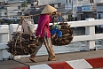 Vietnamese woman walking with wood