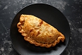 Traditional Cornish pasty filled with beef, potato and vegetables